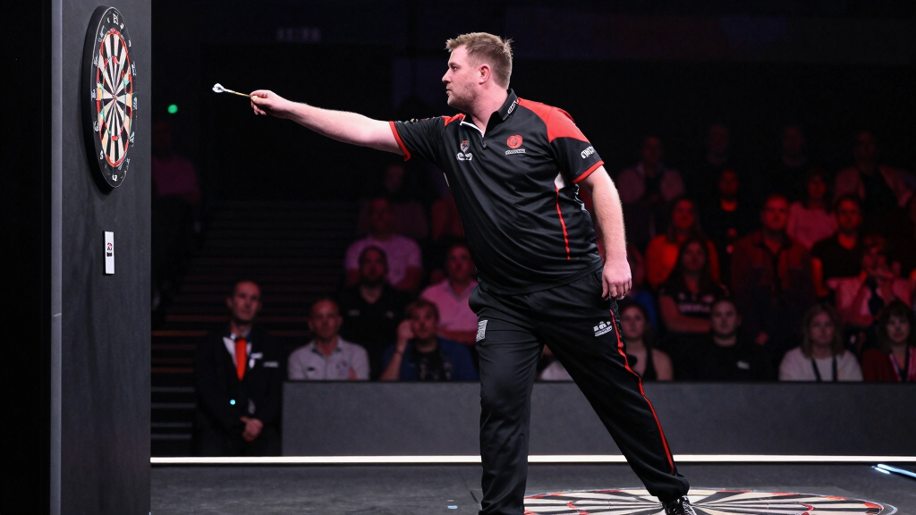 Nathan Aspinall throwing darts at the oche during a PDC event