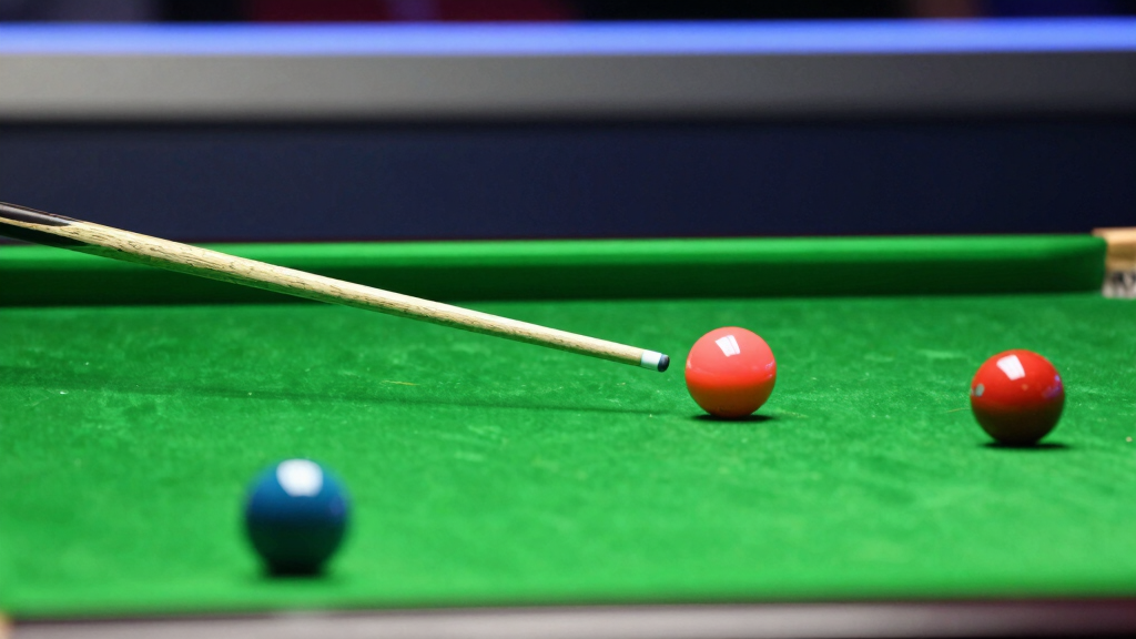 Close-up of snooker cue ball impact on the red ball on green baize, professional lighting