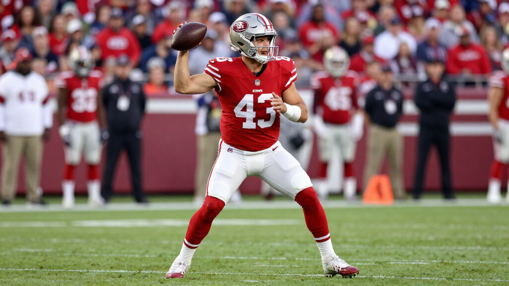 NFL quarterback in red 49ers uniform scanning the field before a snap in professional football game