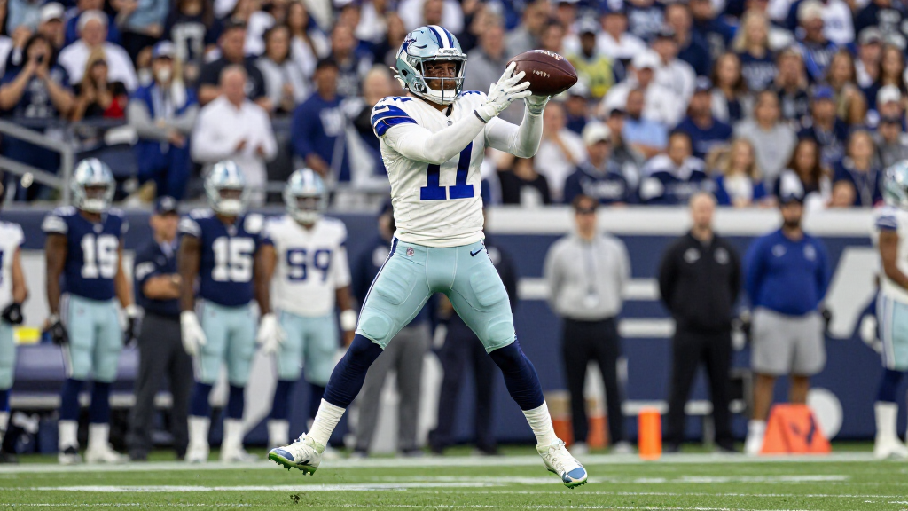 CeeDee Lamb making a catch in Dallas Cowboys white uniform