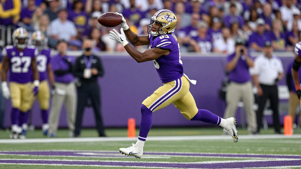 Justin Jefferson leaping to catch a pass in Vikings purple uniform
