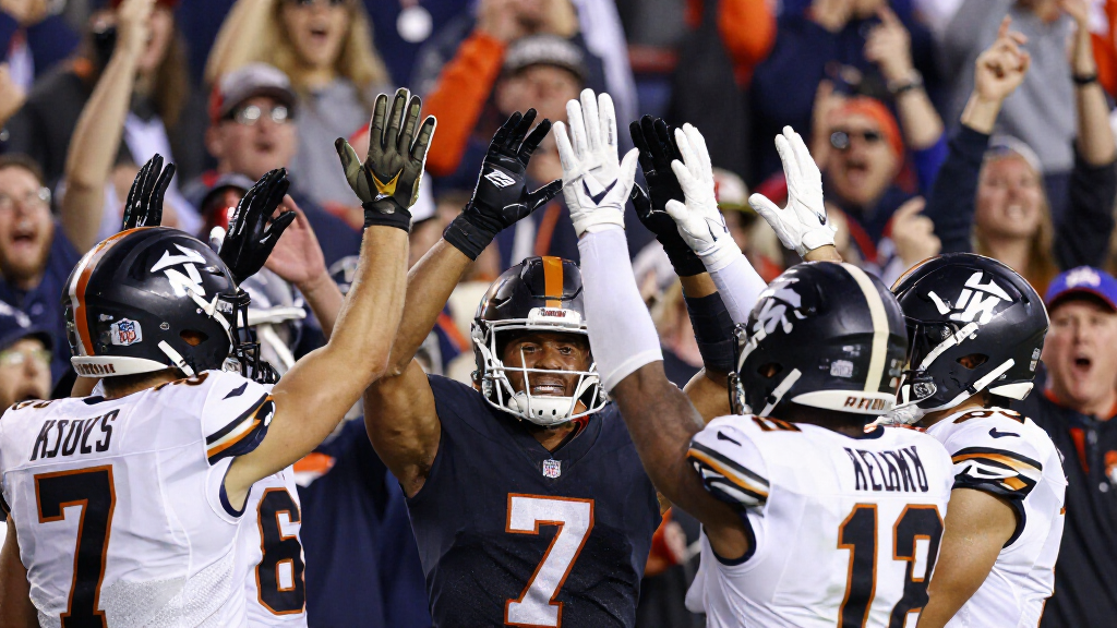 NFL wide receiver celebrating a touchdown catch with teammates