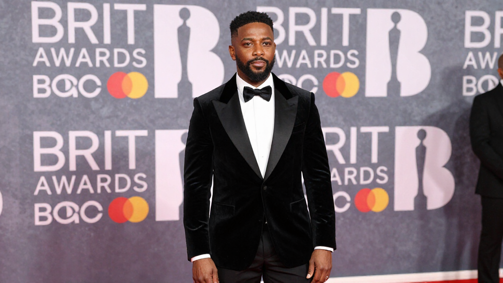 Black British musician at a major music awards ceremony in formal attire
